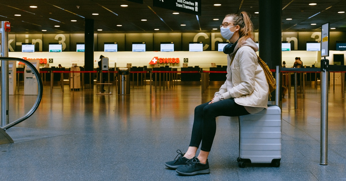 Woman Sitting On Luggage